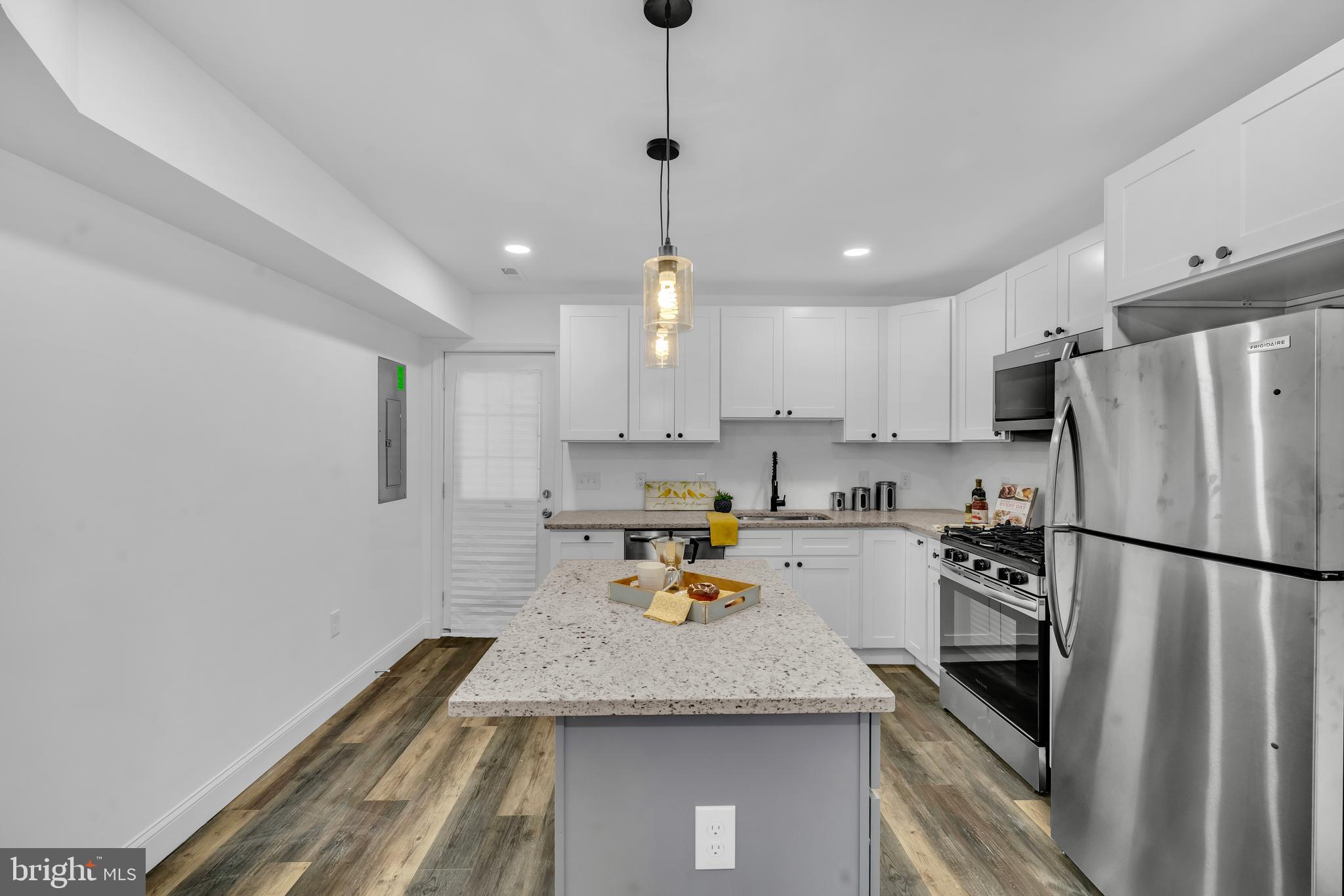 1710 Light Street Baltimore, MD 21230 - Photo 18 of 59 a kitchen with granite countertop stainless steel appliances and a refrigerator