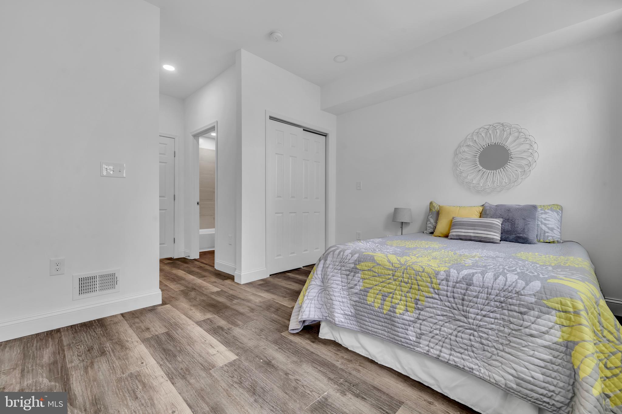 1710 Light Street Baltimore, MD 21230 - Photo 21 of 59 a bedroom with a bed and wooden floor