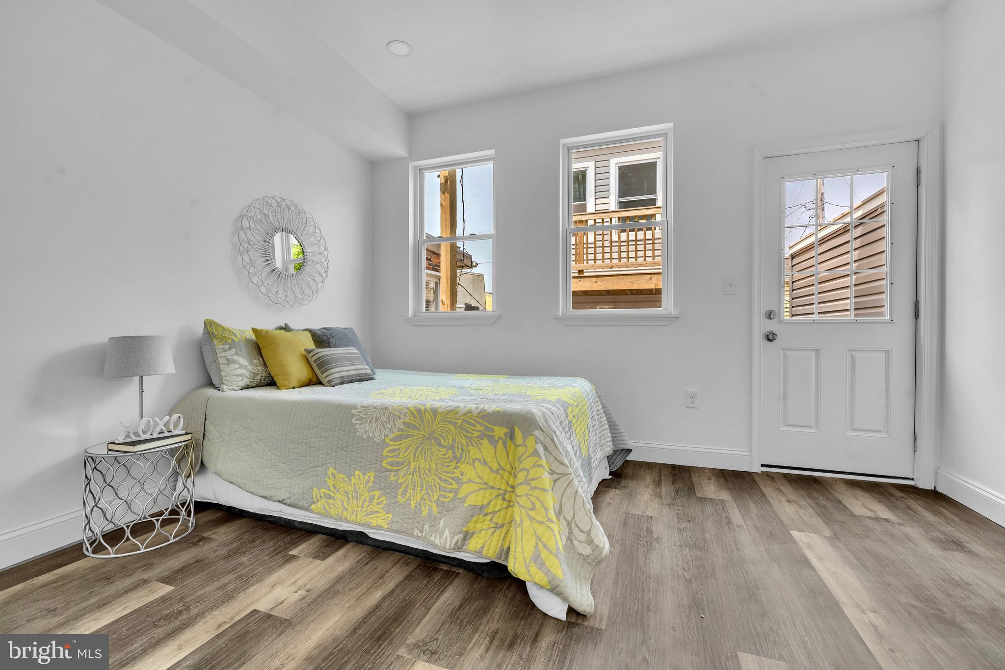 1710 Light Street Baltimore, MD 21230 - Photo 22 of 59 a bed sitting in a bedroom next to a window and a wooden floor