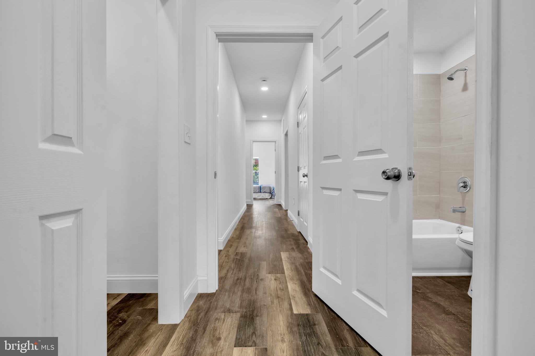1710 Light Street Baltimore, MD 21230 - Photo 23 of 59 a view of a hallway with wooden floor and a bathroom