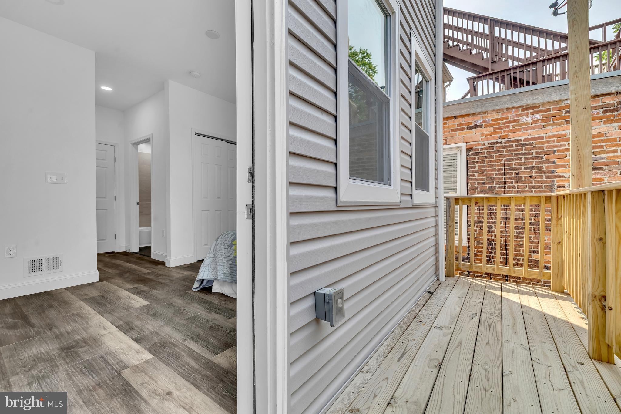 1710 Light Street Baltimore, MD 21230 - Photo 25 of 59 a view of a balcony with wooden floor and fence