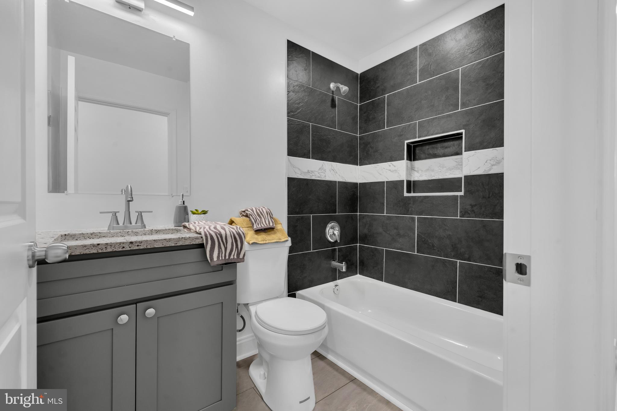 1710 Light Street Baltimore, MD 21230 - Photo 27 of 59 a bathroom with a sink a toilet and shower