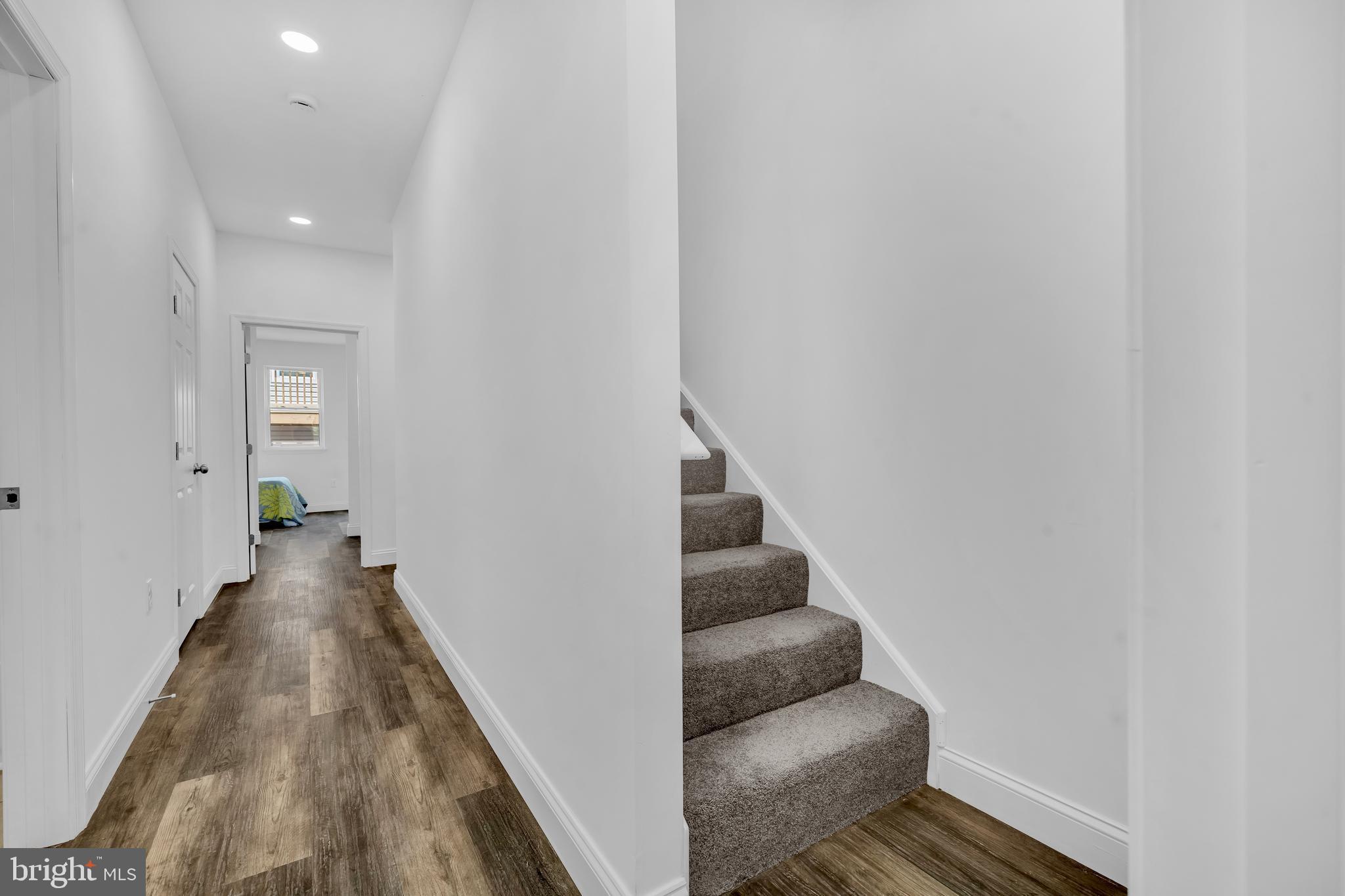 1710 Light Street Baltimore, MD 21230 - Photo 31 of 59 a view of a hallway with wooden floor and staircase