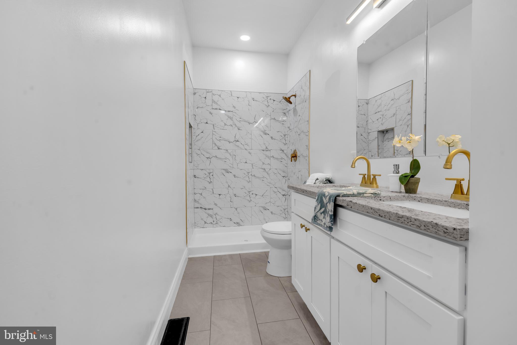 1710 Light Street Baltimore, MD 21230 - Photo 35 of 59 a bathroom with a granite countertop sink a toilet and shower