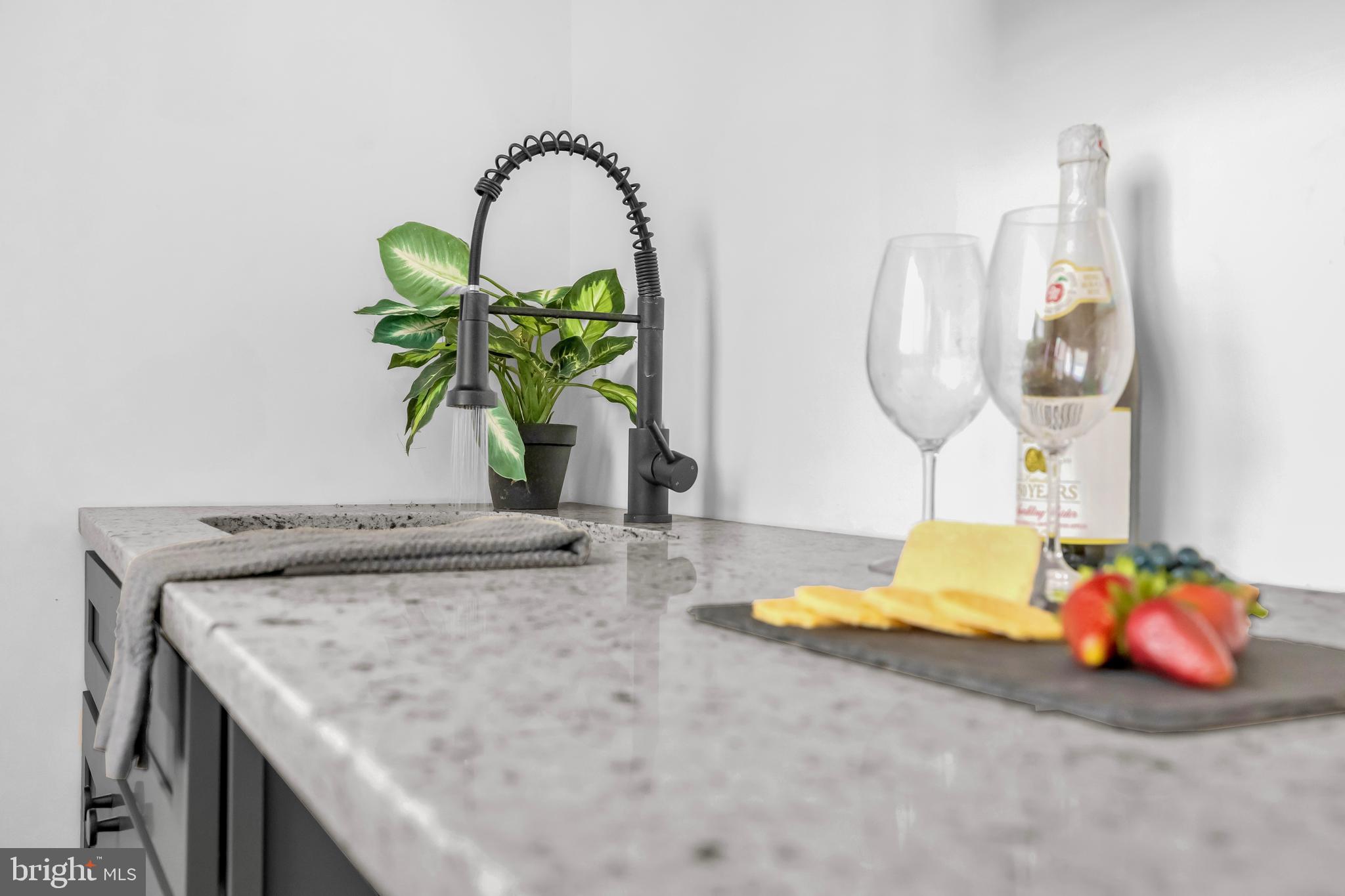 1710 Light Street Baltimore, MD 21230 - Photo 41 of 59 a kitchen with a faucet a stove and a dining table