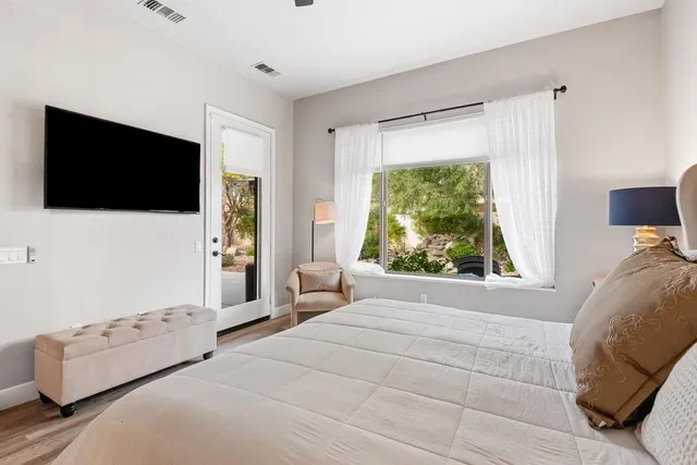 a bedroom with a bed and a flat screen tv