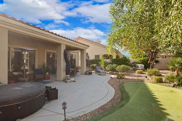 a view of a house with swimming pool and sitting area