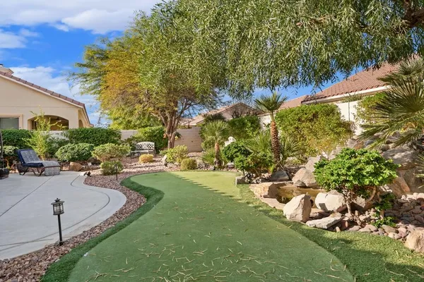 a view of a house with a yard patio and sitting area
