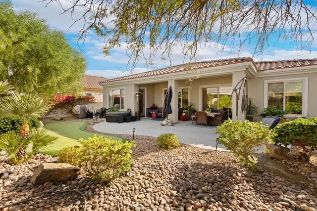 a view of a house with swimming pool and furniture