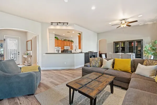a living room with furniture and a chandelier