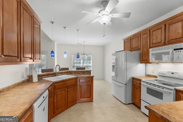a kitchen with a stove top oven and refrigerator