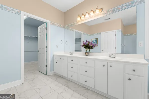 a bathroom with a sink vanity and a mirror