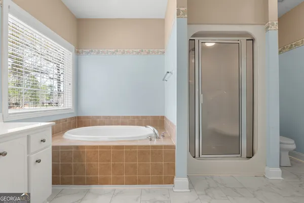 a bathroom with a bathtub and shower