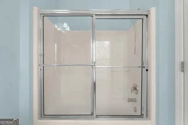 a bathroom with a glass shower door