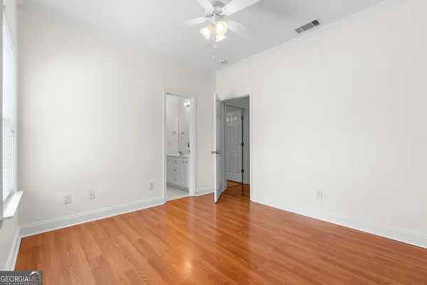 a view of empty room with wooden floor