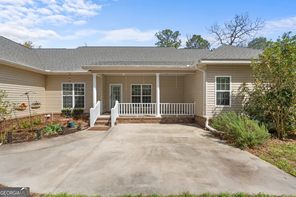 a front view of a house with a big yard