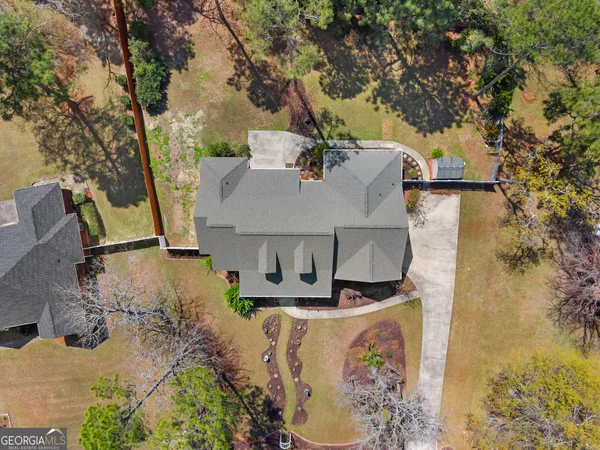 aerial view of a house with large trees