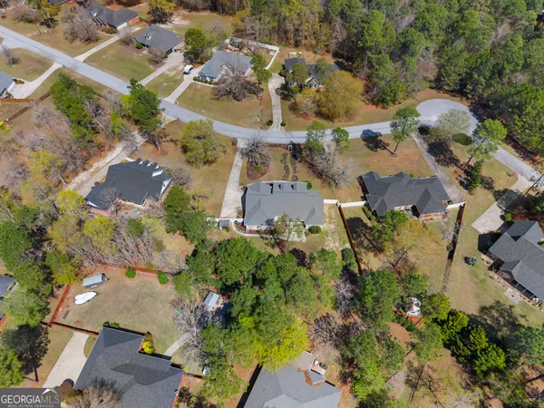 an aerial view of a house with yard swimming pool and outdoor seating