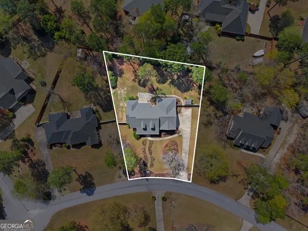 an aerial view of a house with a yard