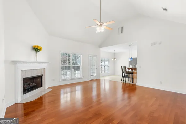 a view of an empty room with a fireplace and a window