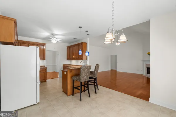 a view of a dining room with furniture and a chandelier