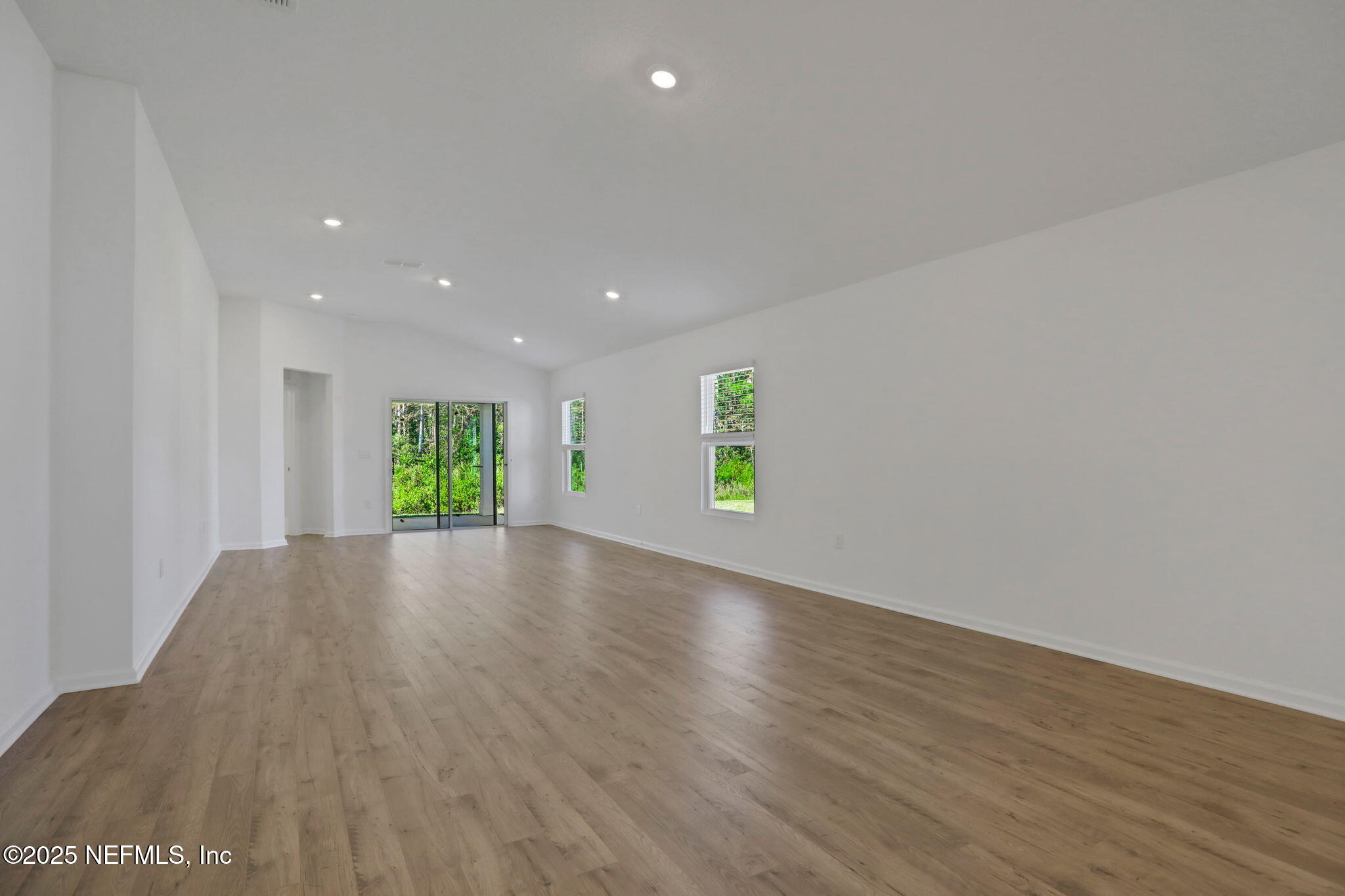 329 Pinzon Place St. Augustine, FL 32095 - Photo 16 of 36 a view of an empty room with a window and wooden floor