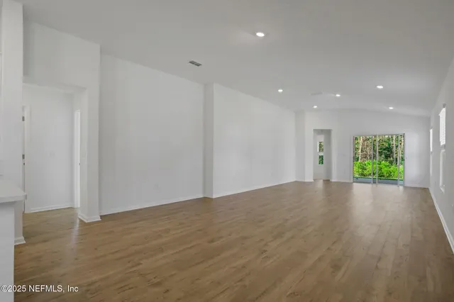 a kitchen with granite countertop a sink stove and microwave