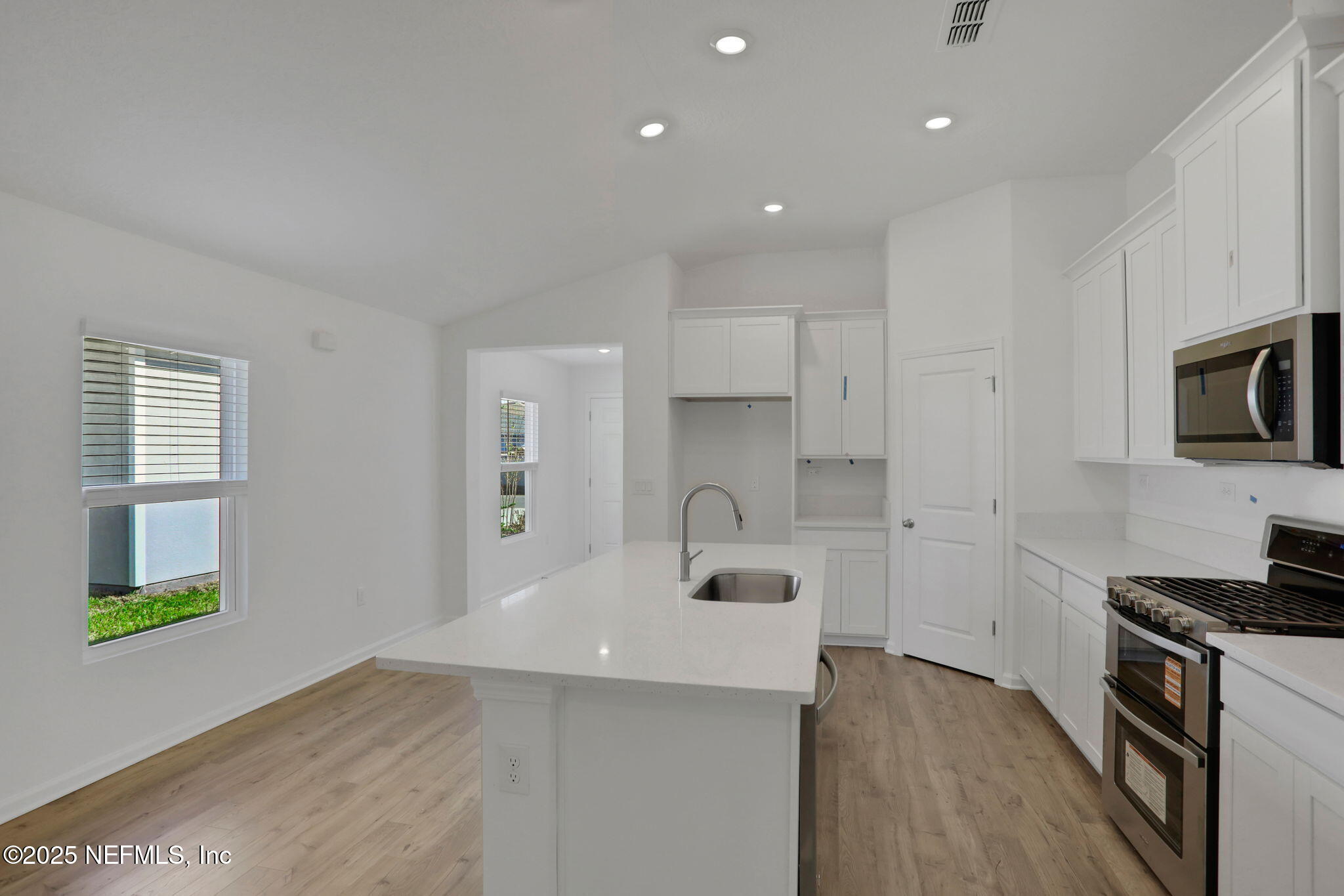 329 Pinzon Place St. Augustine, FL 32095 - Photo 19 of 36 a kitchen with kitchen island a sink stainless steel appliances and cabinets