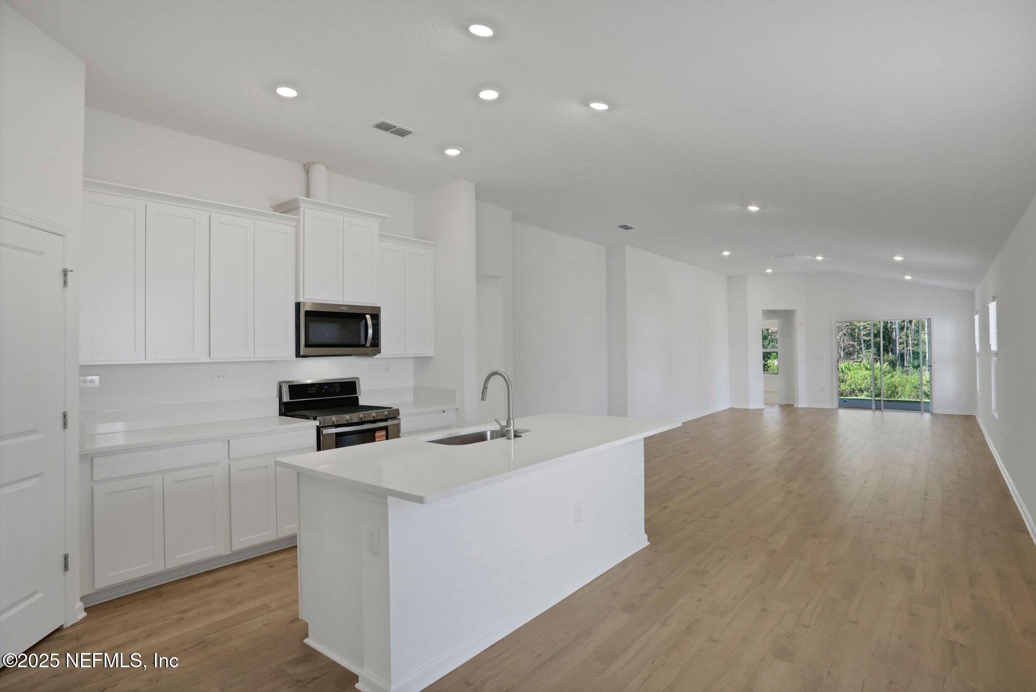 329 Pinzon Place St. Augustine, FL 32095 - Photo 22 of 36 a kitchen with stainless steel appliances a stove top oven a sink a refrigerator and white cabinets