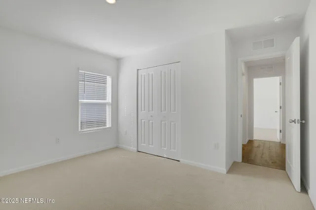 a view of an empty room and a window