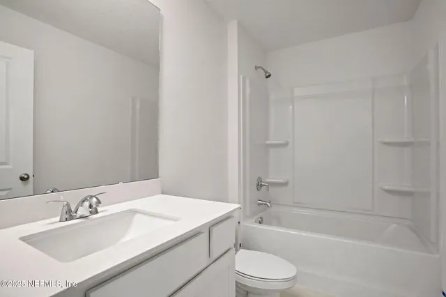 a bathroom with double vanity sinks and a mirror