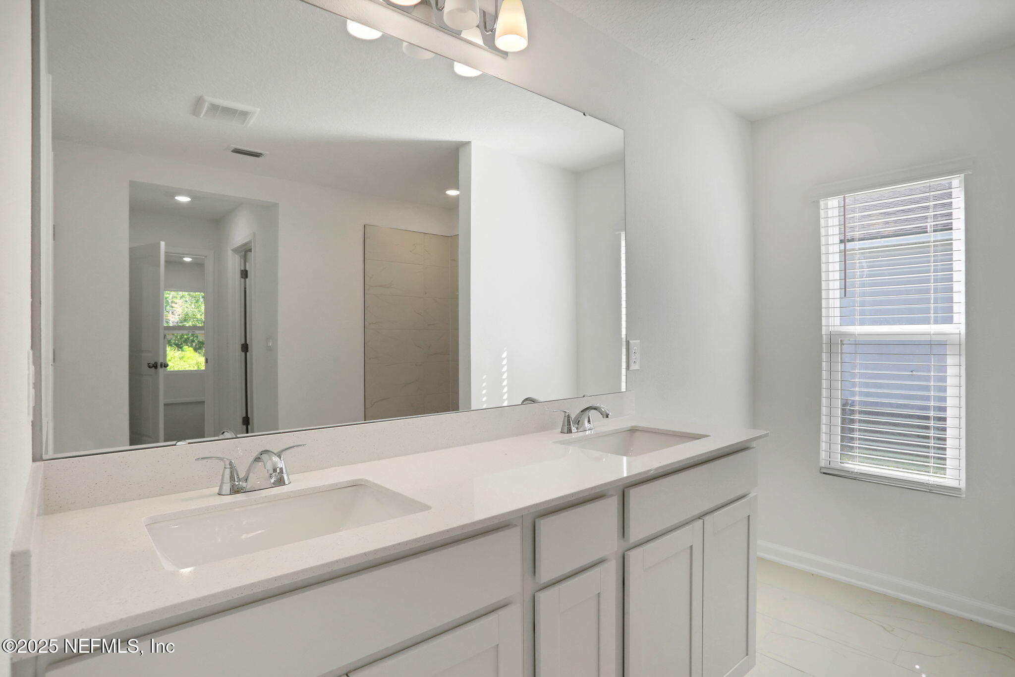 329 Pinzon Place St. Augustine, FL 32095 - Photo 28 of 36 a bathroom with double vanity sinks and a mirror