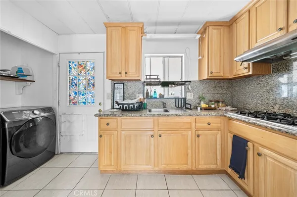 a kitchen with a sink cabinets and washer