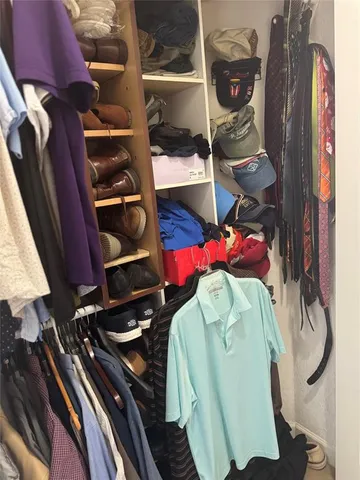 a bedroom with a bed and a flat tv screen on the dresser