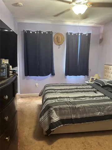 a view of bedroom with wooden floor