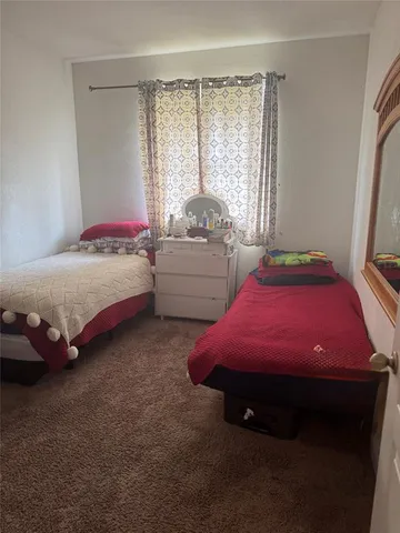 a bed room with a bed and gym equipment