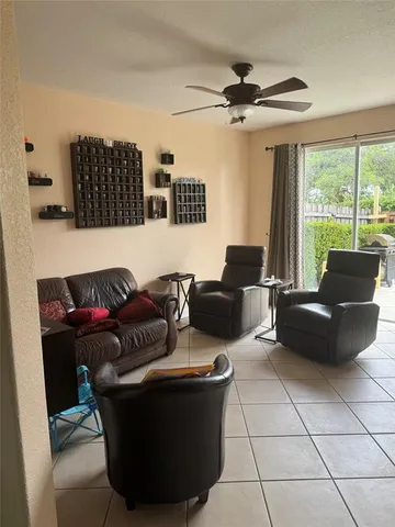 a living room with furniture and a floor to ceiling window