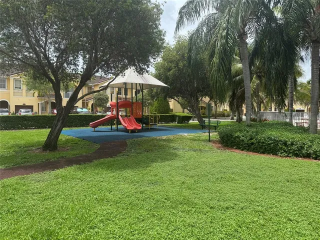 a swimming pool with outdoor seating and yard