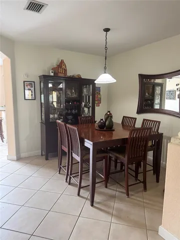 a view of a dining room with furniture and chandelier