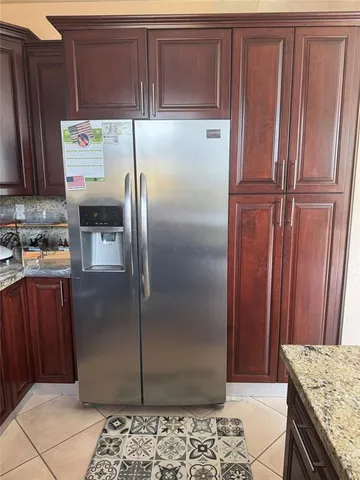 a kitchen with stainless steel appliances granite countertop a refrigerator and a counter