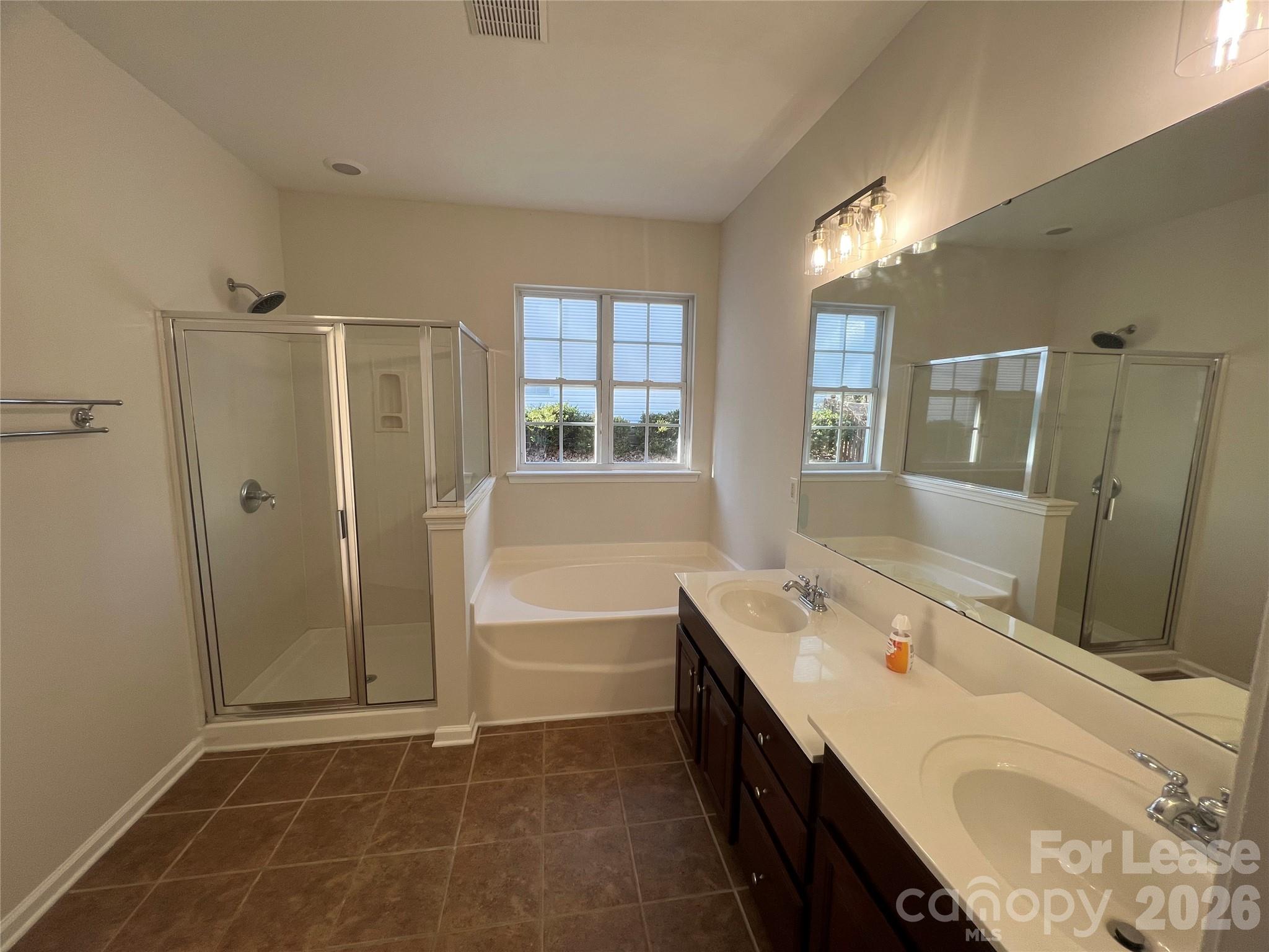 5002 Fine Robe Drive Indian Trail, NC 28079 - Photo 19 of 25 a bathroom with a tub sink double vanity granite tub and shower