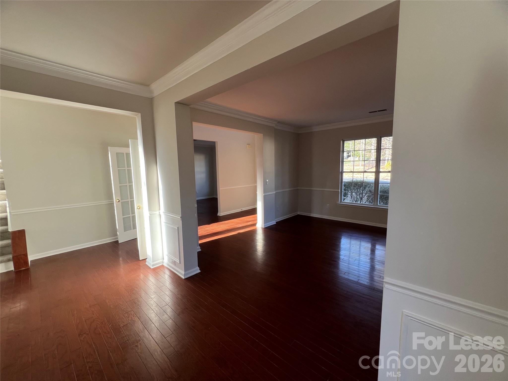 5002 Fine Robe Drive Indian Trail, NC 28079 - Photo 3 of 25 an empty room with wooden floor and windows