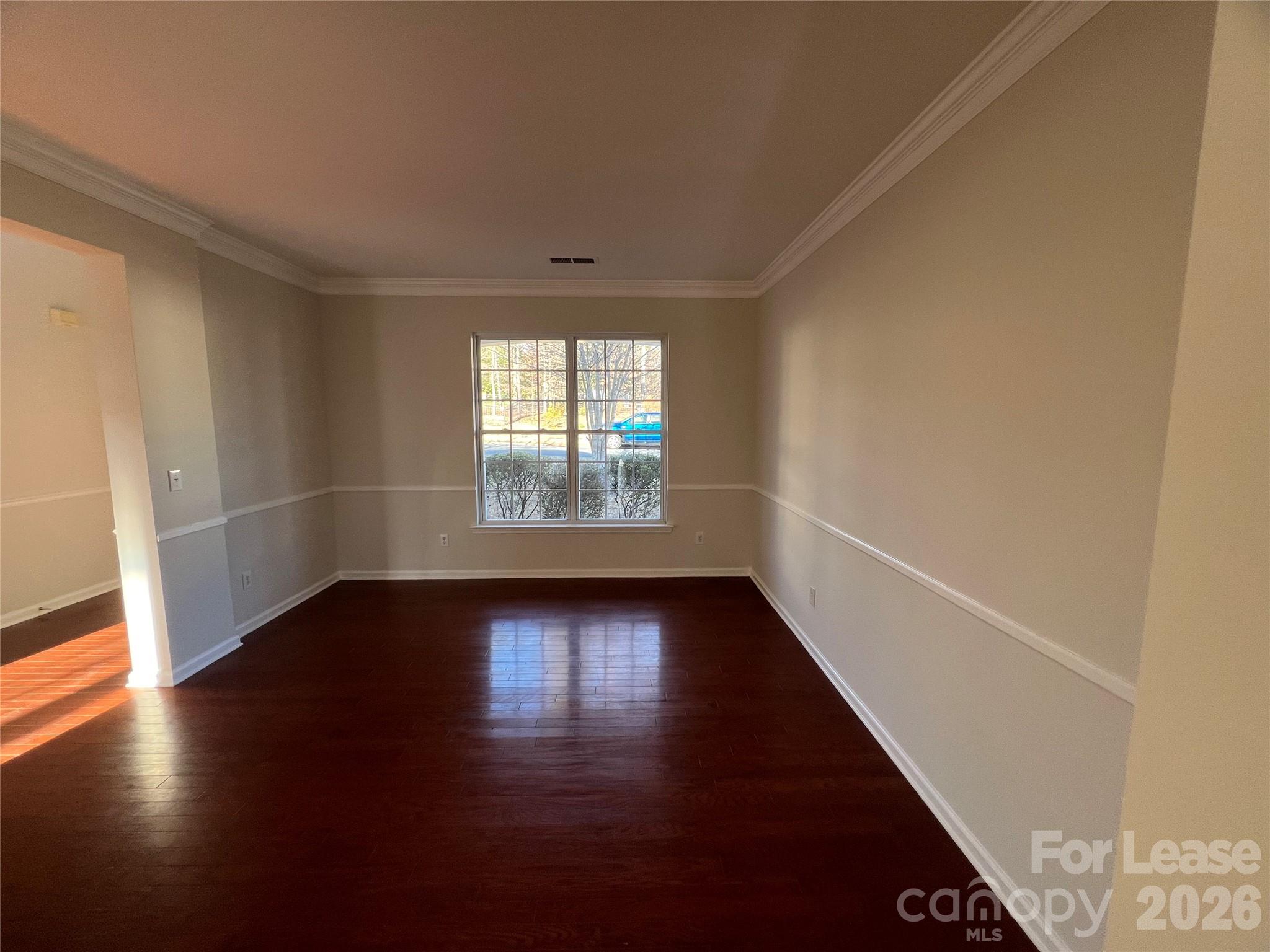 5002 Fine Robe Drive Indian Trail, NC 28079 - Photo 5 of 25 an empty room with wooden floor and windows
