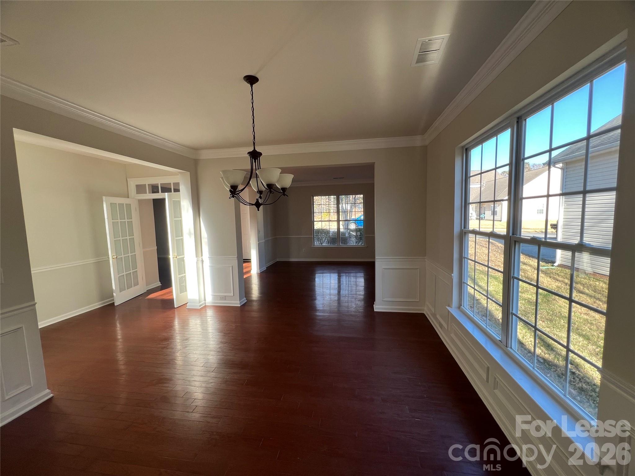 5002 Fine Robe Drive Indian Trail, NC 28079 - Photo 6 of 25 a view of an empty room with wooden floor and a window