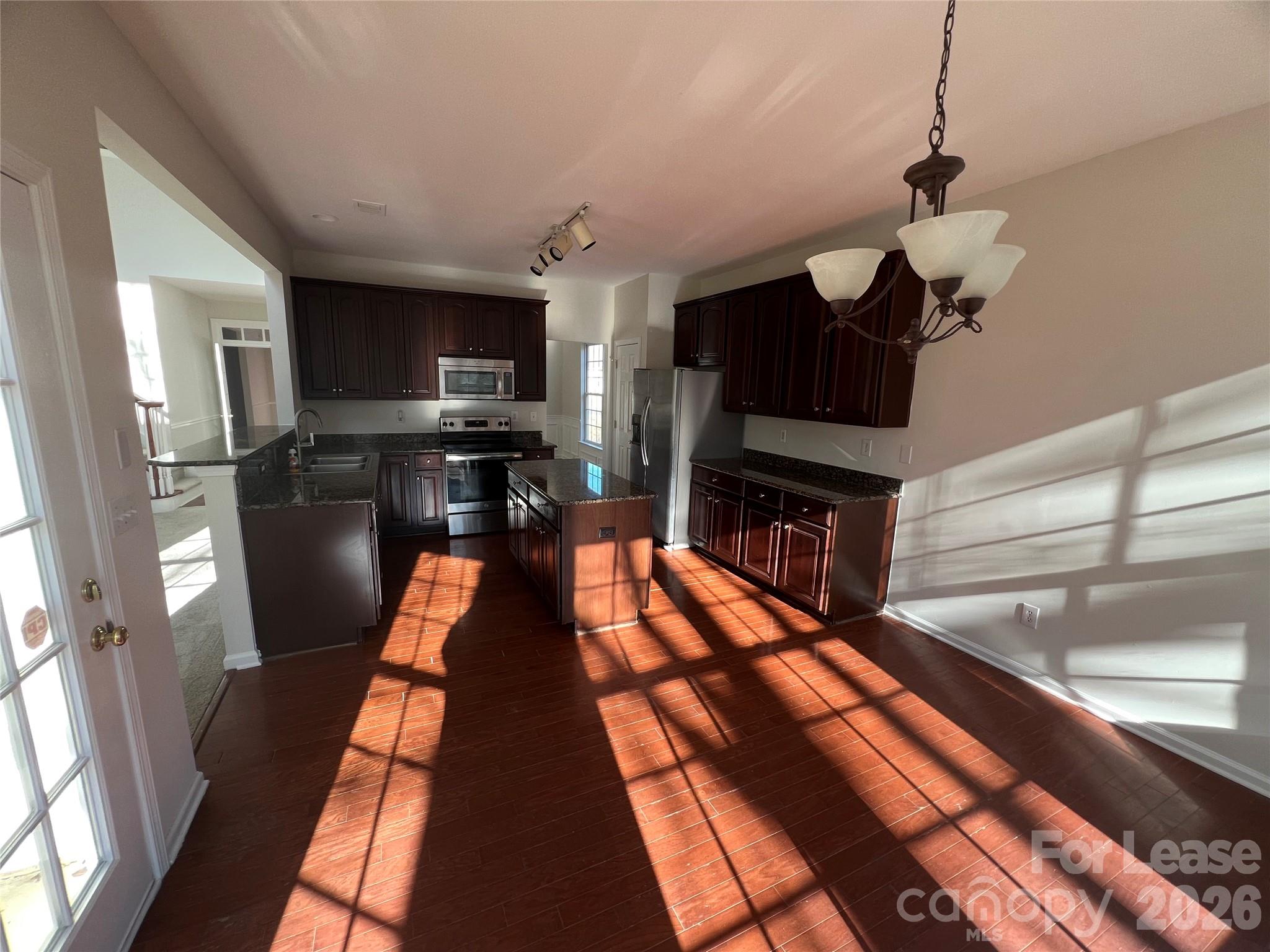 5002 Fine Robe Drive Indian Trail, NC 28079 - Photo 8 of 25 a very nice looking open kitchen with stainless steel appliances granite countertop a refrigerator a stove top oven a sink and dishwasher