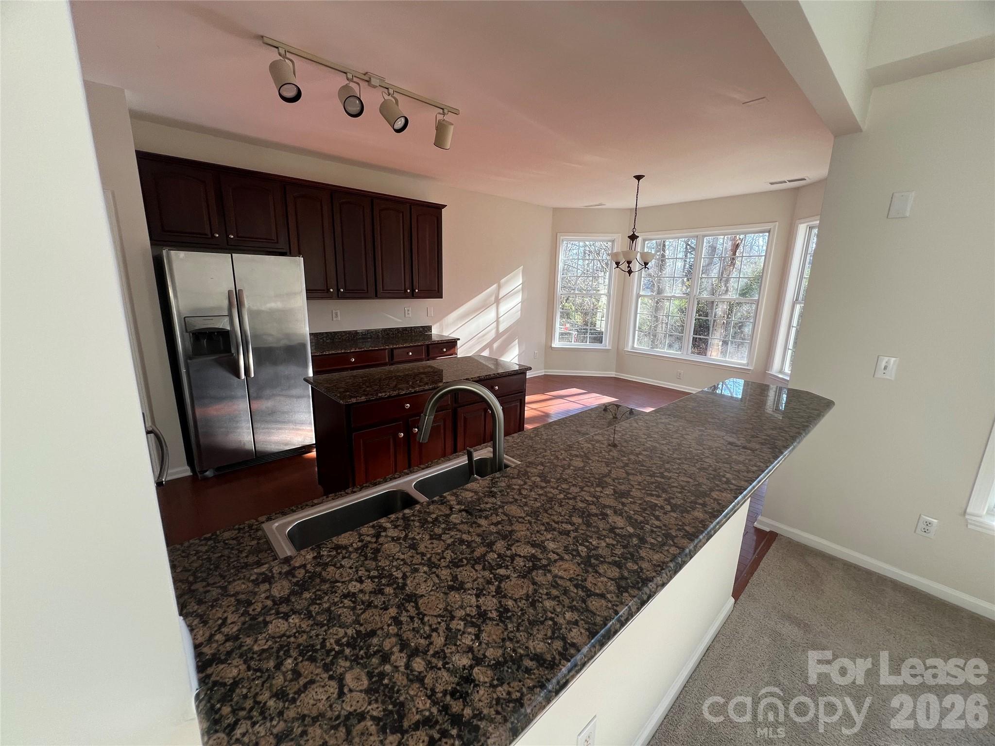 5002 Fine Robe Drive Indian Trail, NC 28079 - Photo 9 of 25 a kitchen with a sink a stove and refrigerator