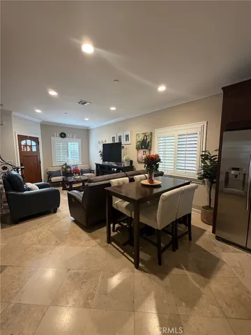 a living room with furniture kitchen view and a refrigerator