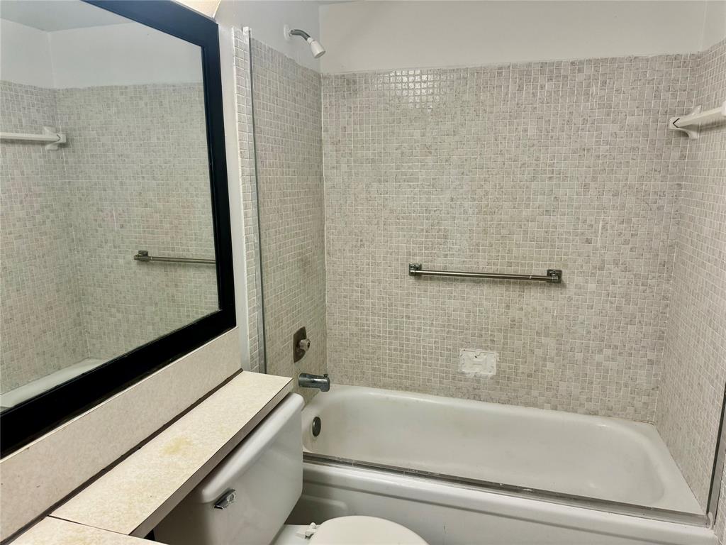 West Deerfield Beach Deerfield Beach, FL 33442 - Photo 18 of 22 a bathroom with a bathtub and a shower