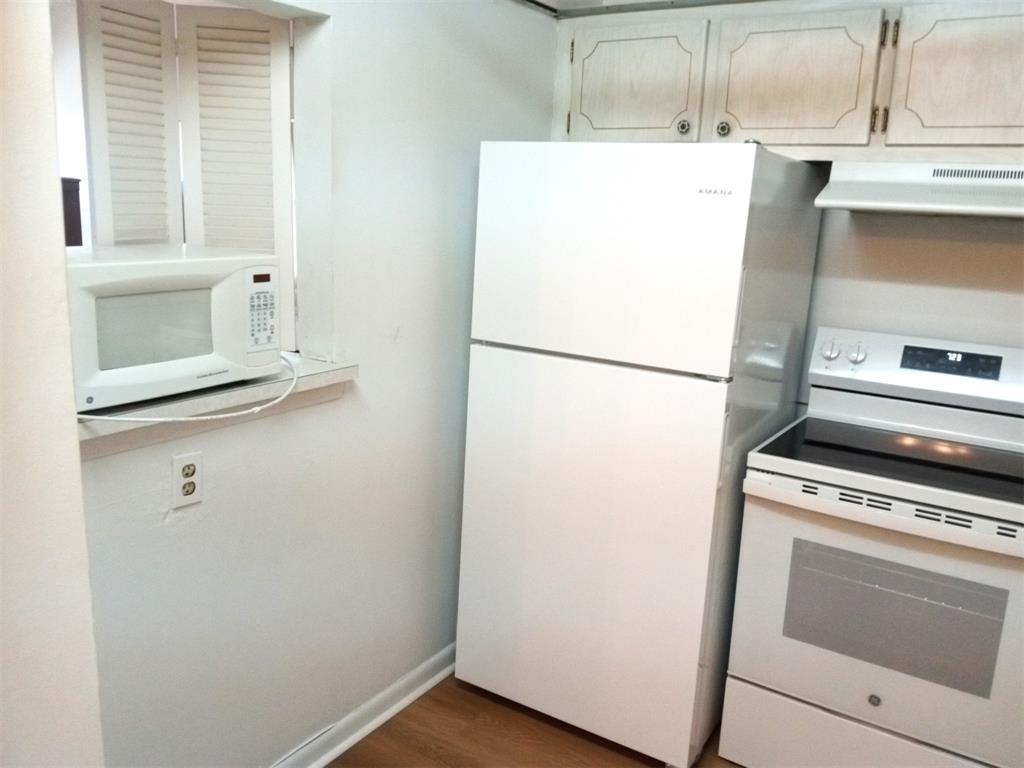 West Deerfield Beach Deerfield Beach, FL 33442 - Photo 3 of 22 a white refrigerator freezer and a stove sitting inside of a kitchen
