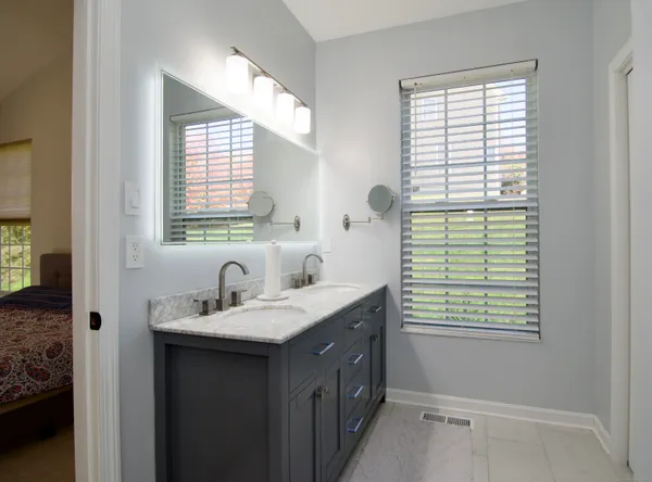a bathroom with a sink window and a mirror